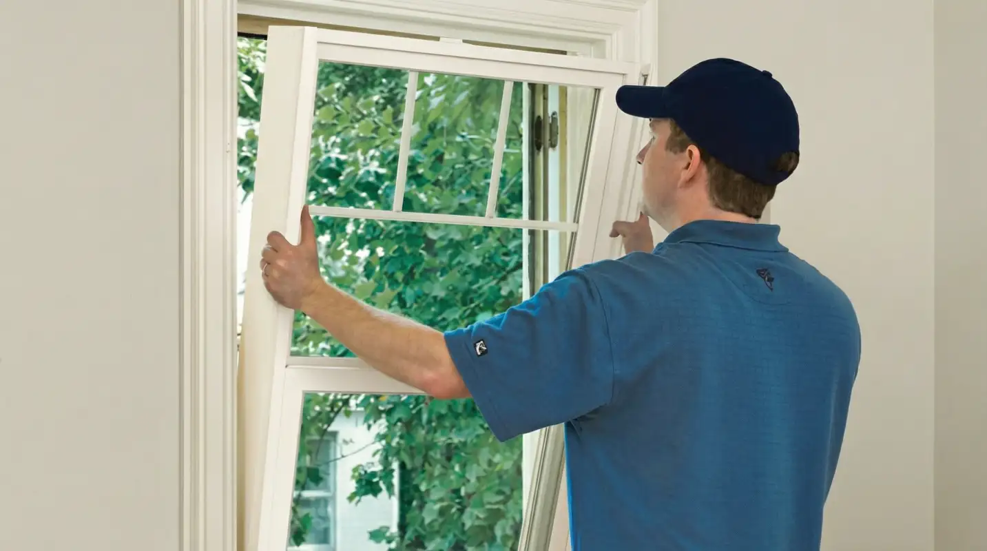 Professional contractors performing a residential window insulation and replacement service in Dover, DE